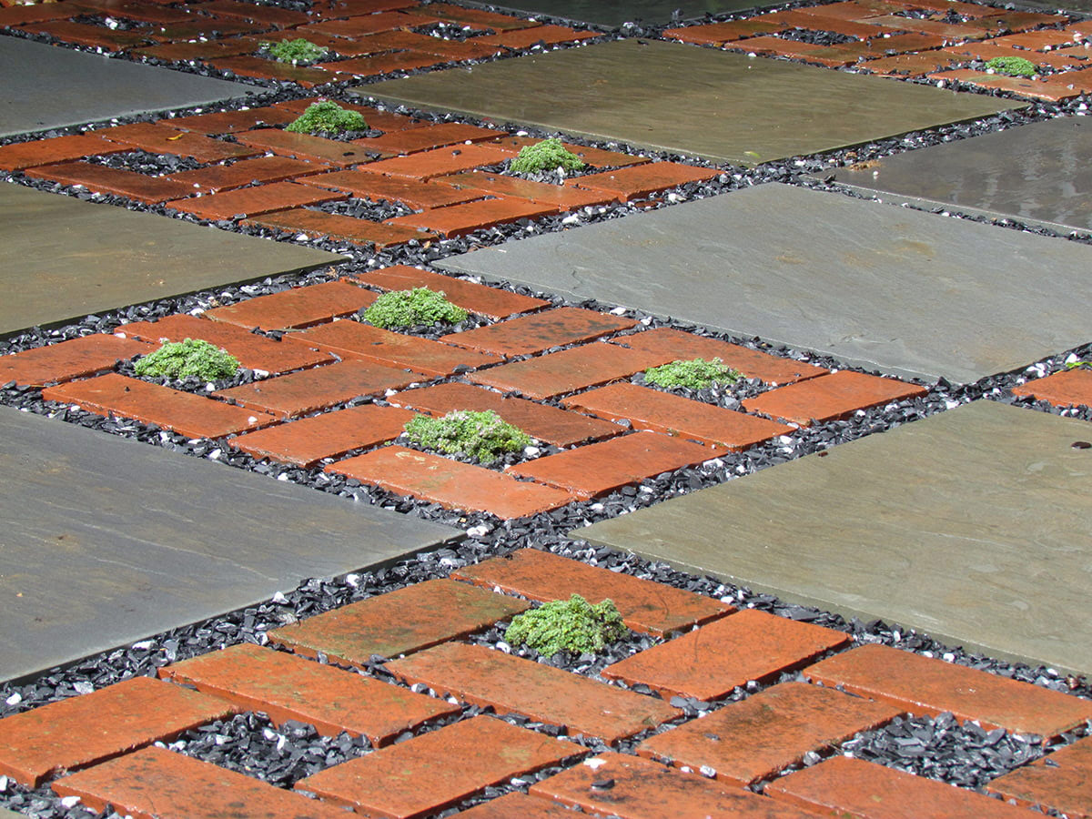 brick and stone patio with gravel in between joints