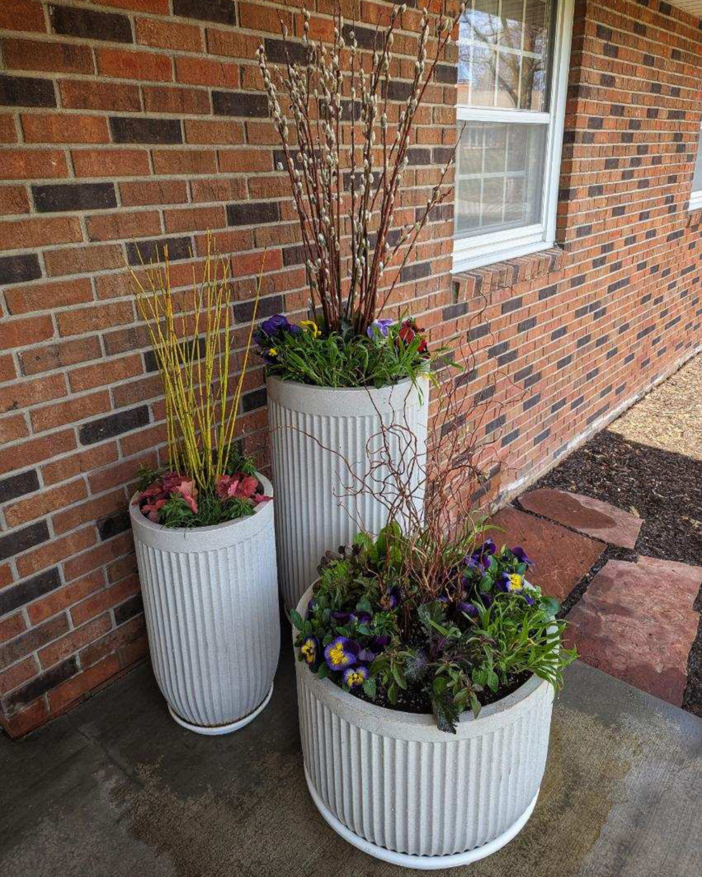 a grouping of spring containers with decorative stems