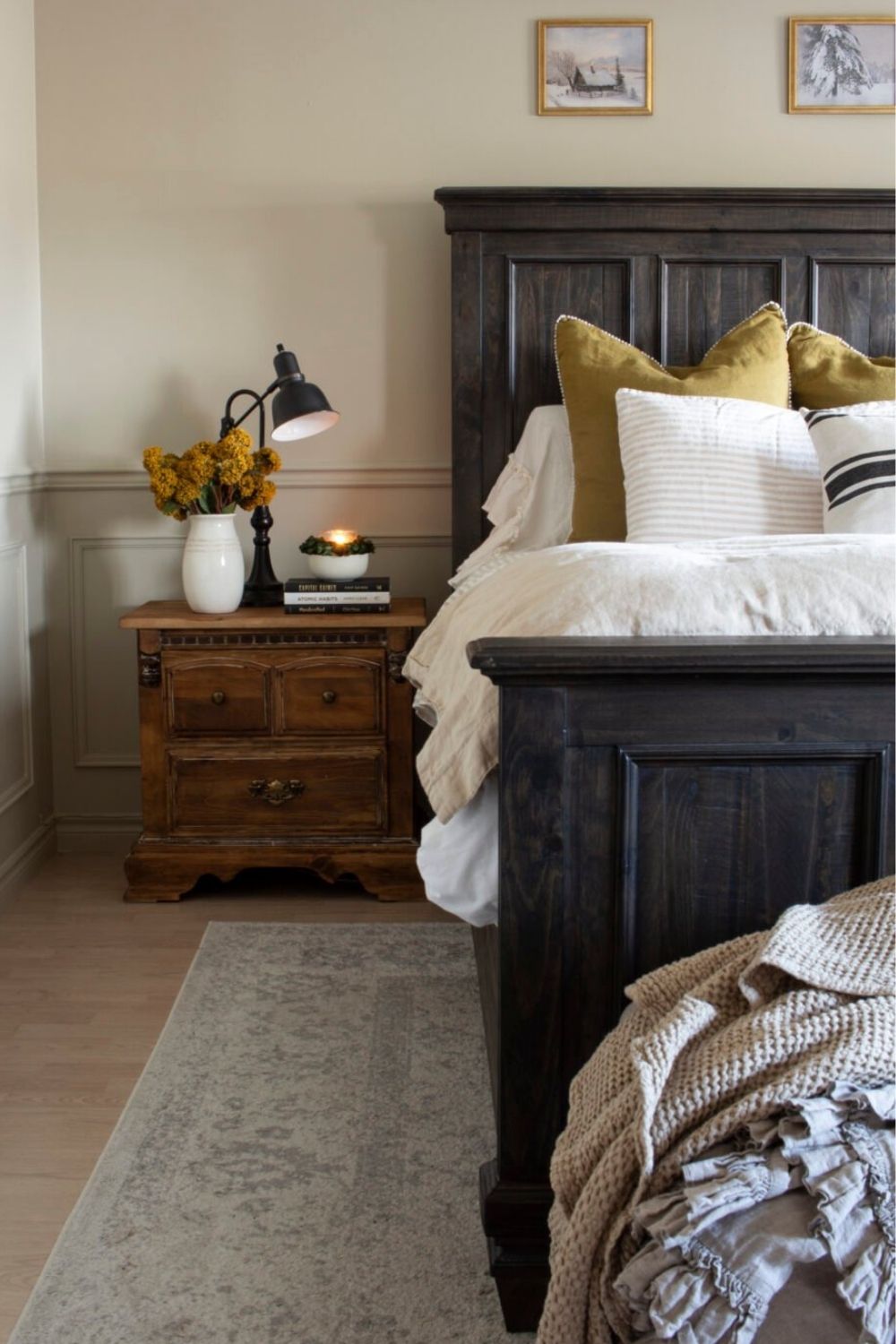 A short distressed-wood nightstand is next to a dark wood king-sized bed. The link leads to 